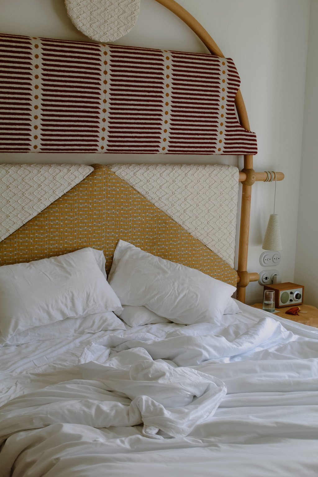 Guest bed with a geometric yellow headboard