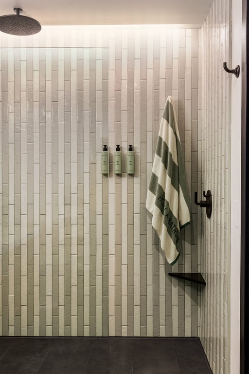 Striped tile shower in a Hotel Albatross guest room