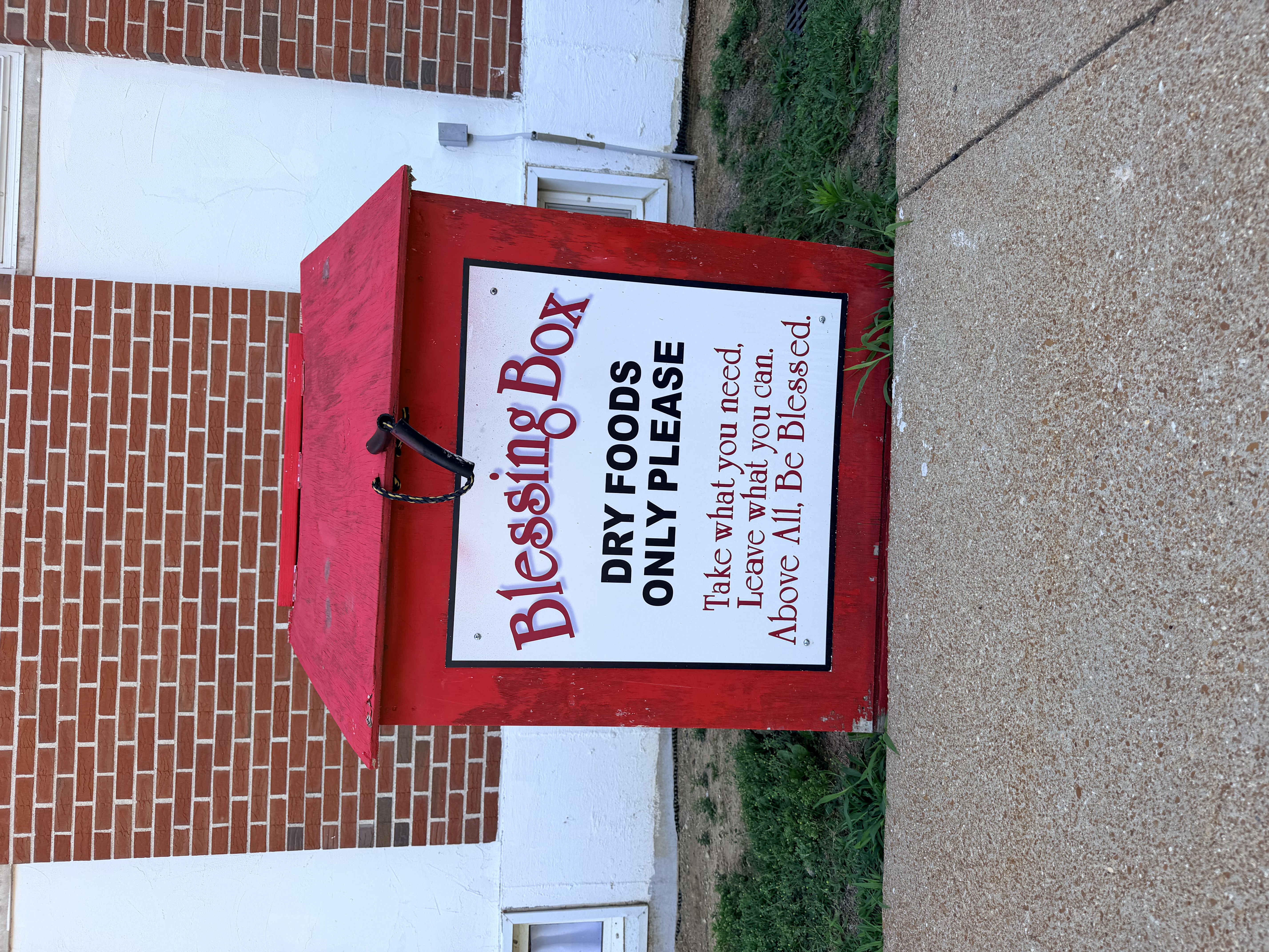 Blessing Box outside The Salvation Army with sign reading take what you need leave what you can