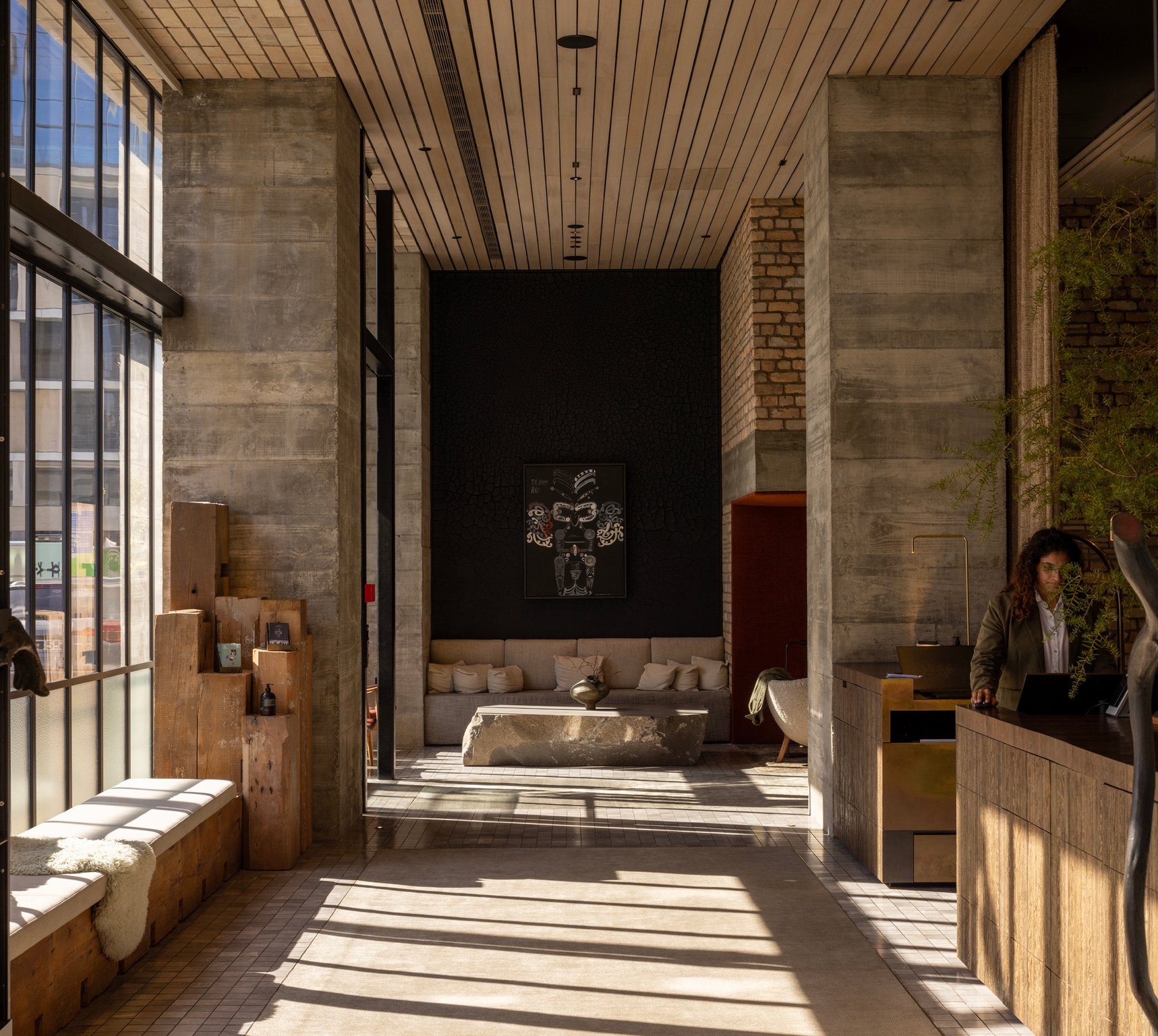 Sunlit brick and timber lobby at Hotel Britomart