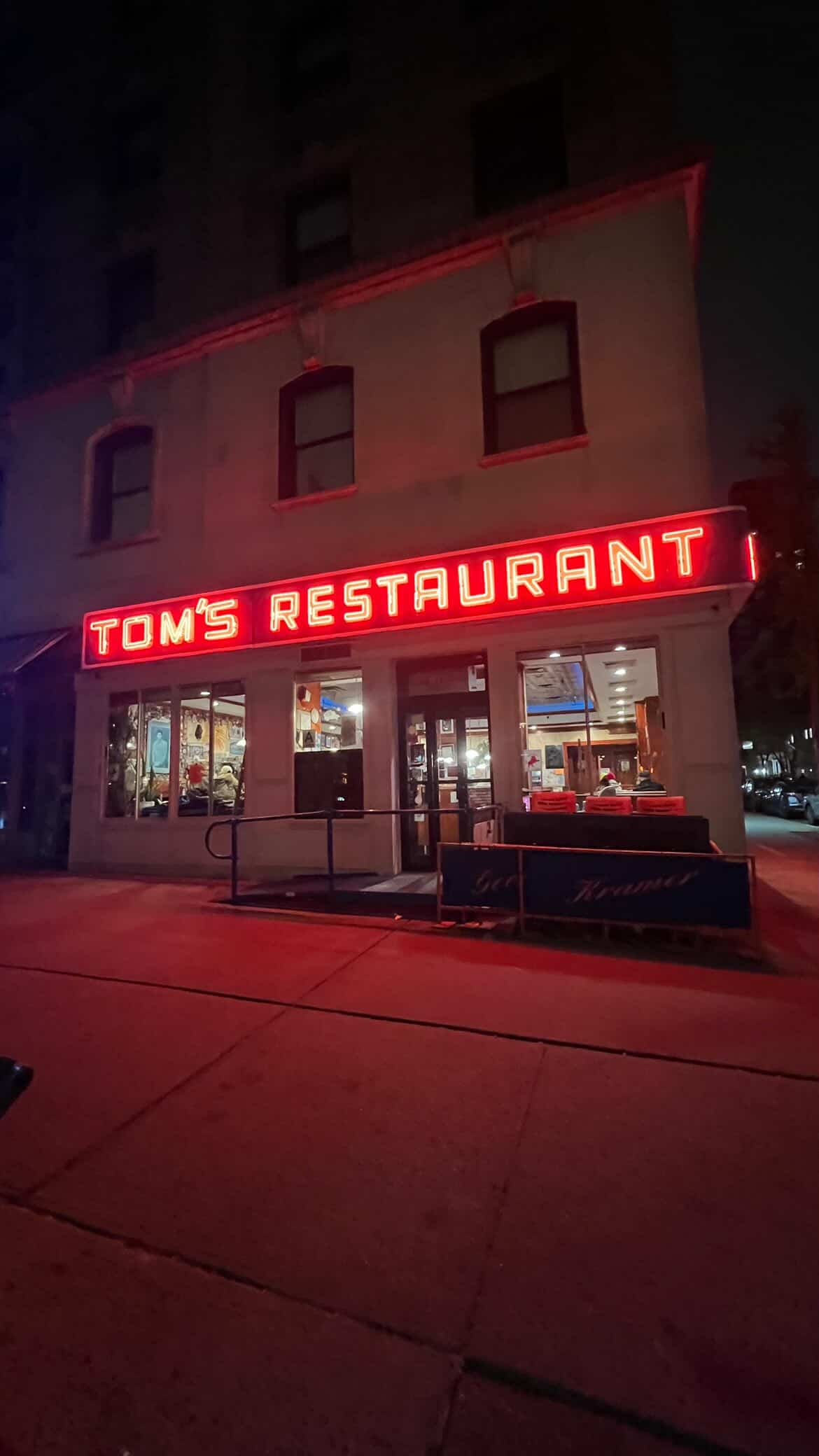 Tom's Restaurant at Broadway and 112th, the red neon Restaurant sign lit.
