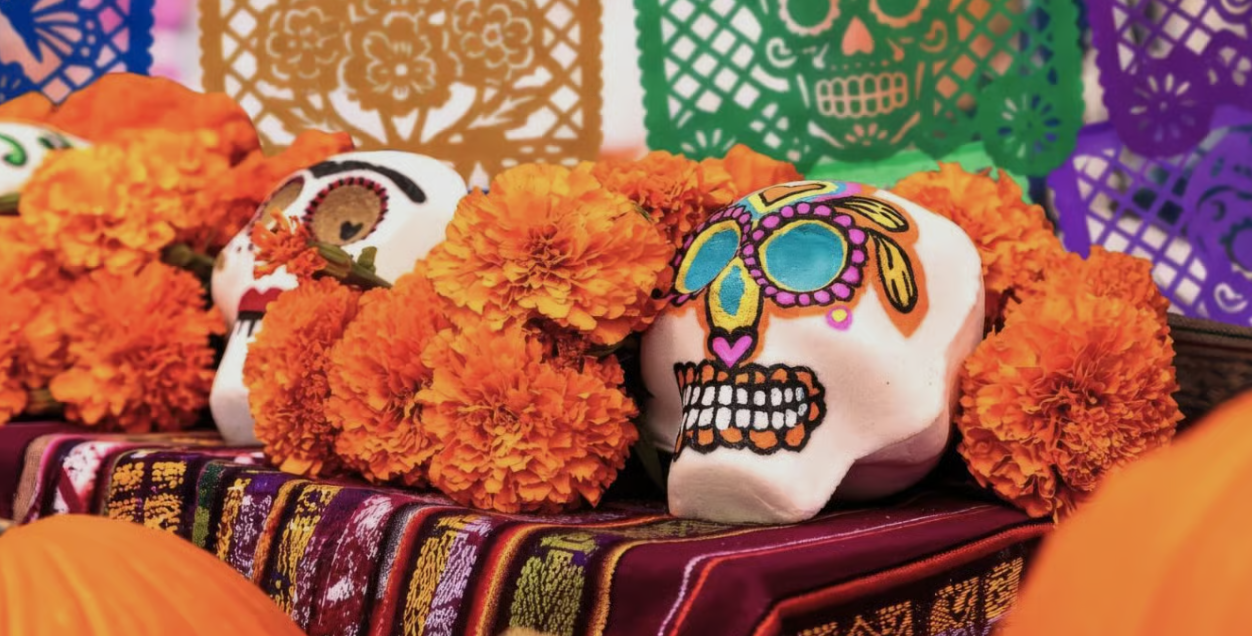 Marigolds, sugar skulls and papel picado on a D&iacute;a de los Muertos altar