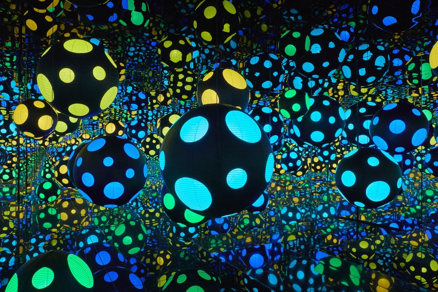 Glowing dotted spheres reflected endlessly in a mirrored room