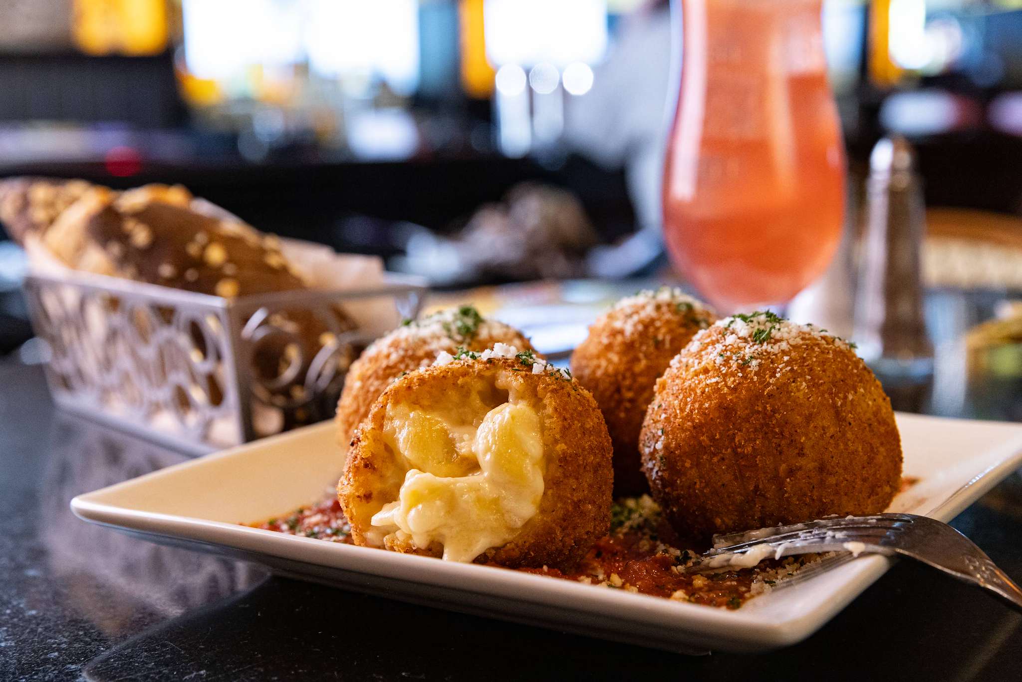 Breaded macaroni-and-cheese bites on a plate in a Cheesecake Factory publicity photo