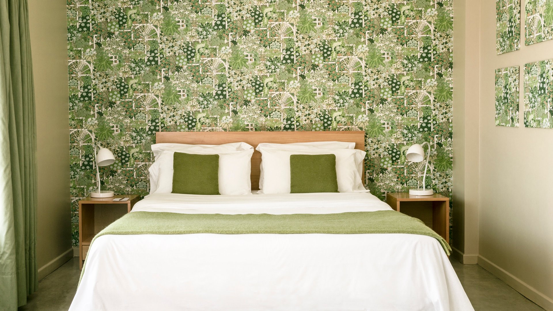 Guest room with green floral wallpaper at Home Hotel