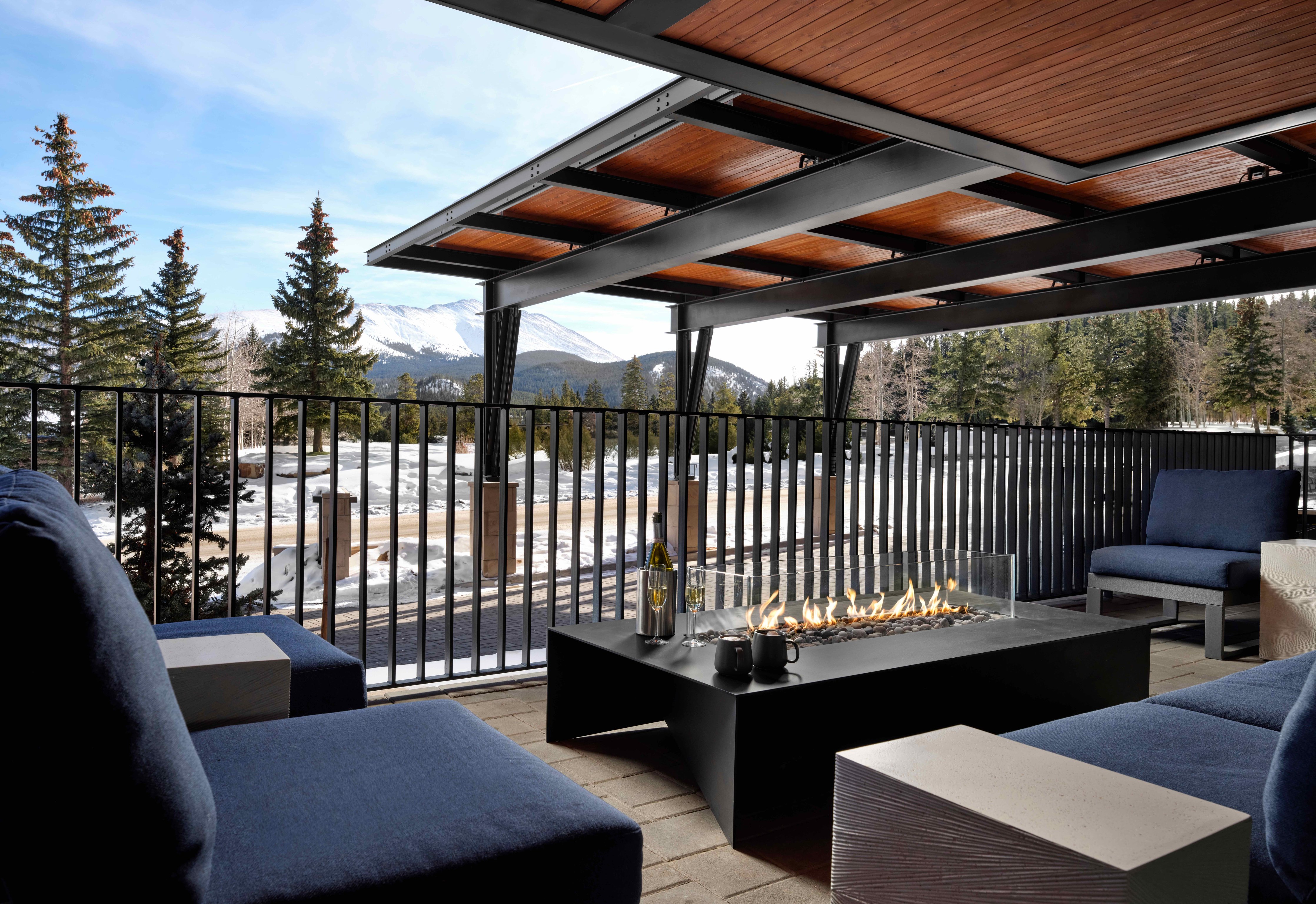 Covered outdoor lounge with a fire table at Hotel Alpenrock Breckenridge