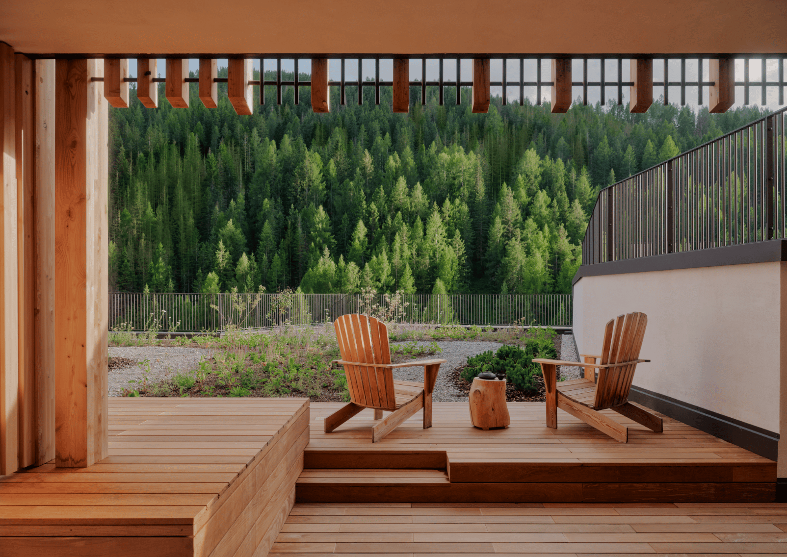 Timber wellness terrace overlooking forested Dolomite slopes