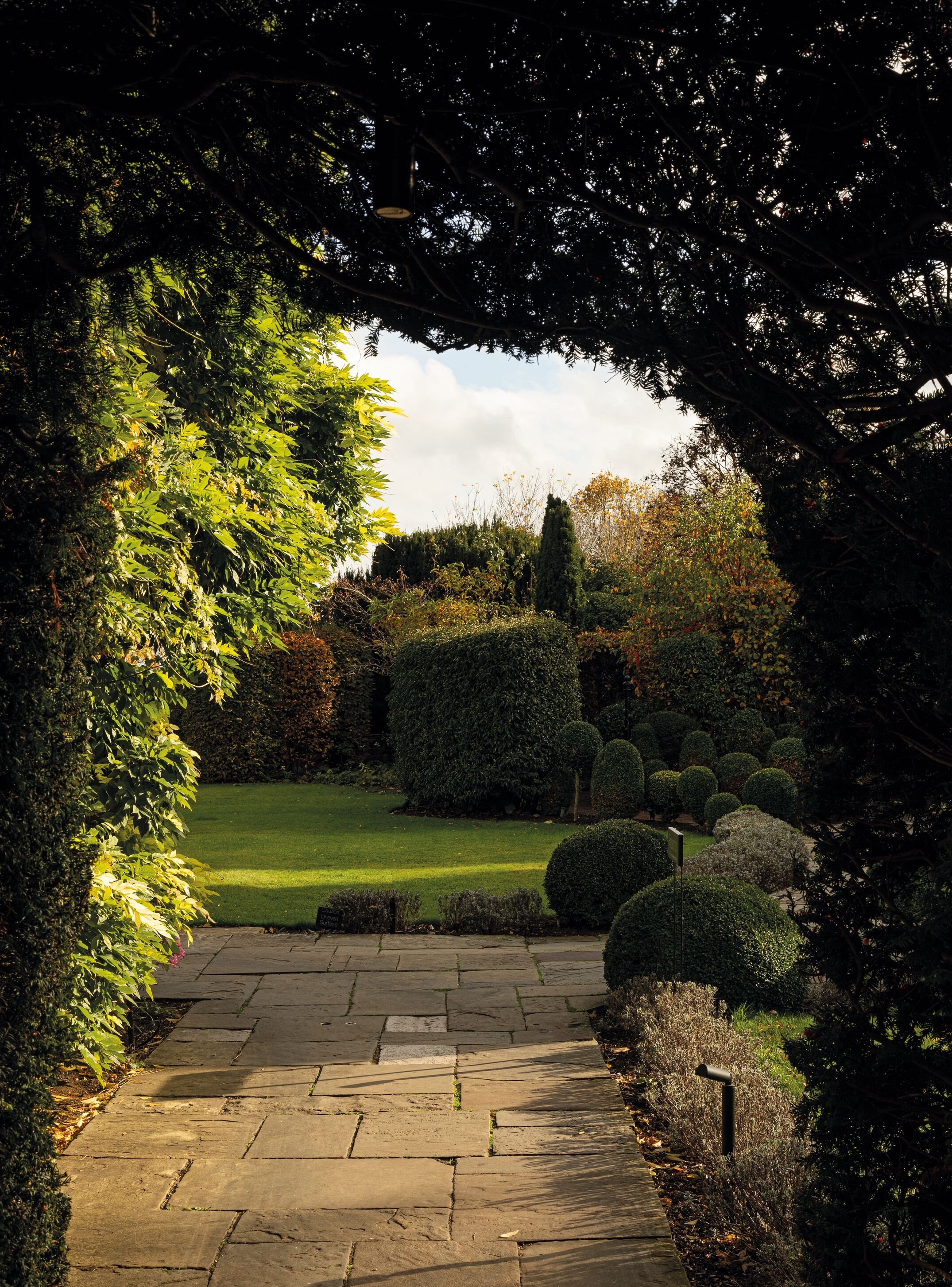 Sculpted hedges and garden paths at Le Manoir aux Quat’Saisons