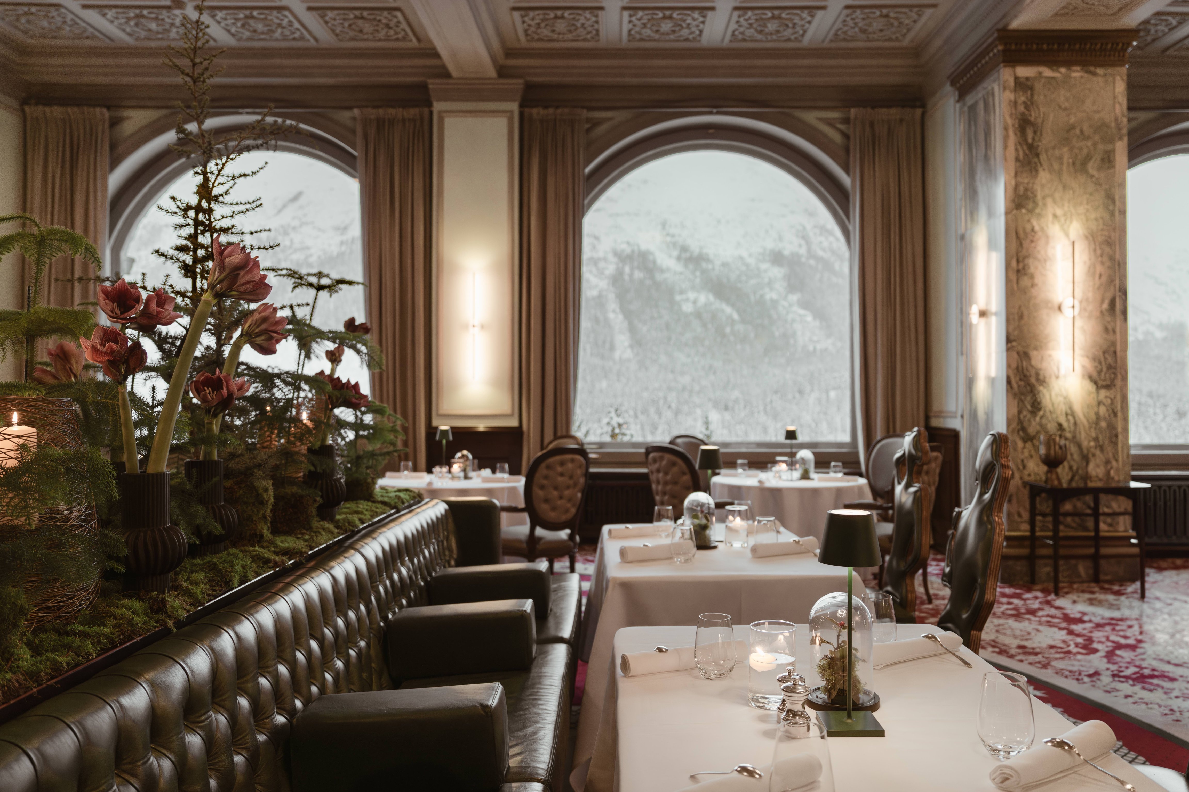 Grand Restaurant with arched mountain-view windows at Carlton Hotel St. Moritz