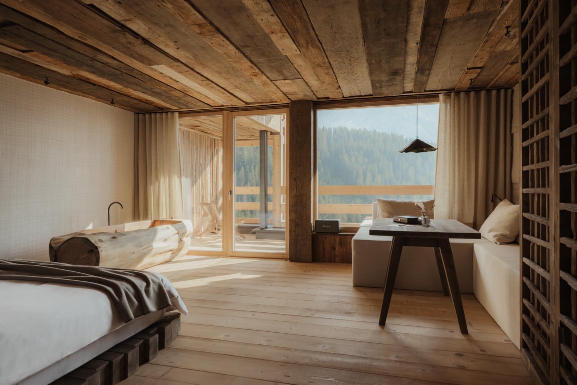 Natural-wood Eriro guest room overlooking alpine slopes