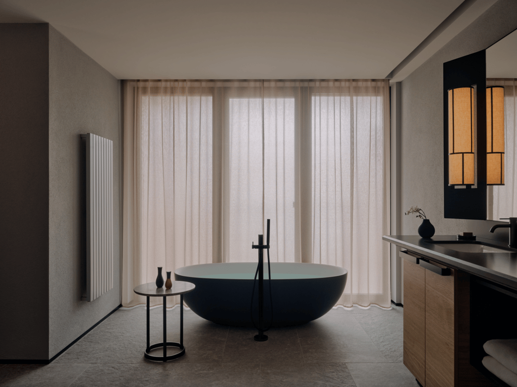 Minimalist bathroom with a freestanding tub at Aman Rosa Alpina