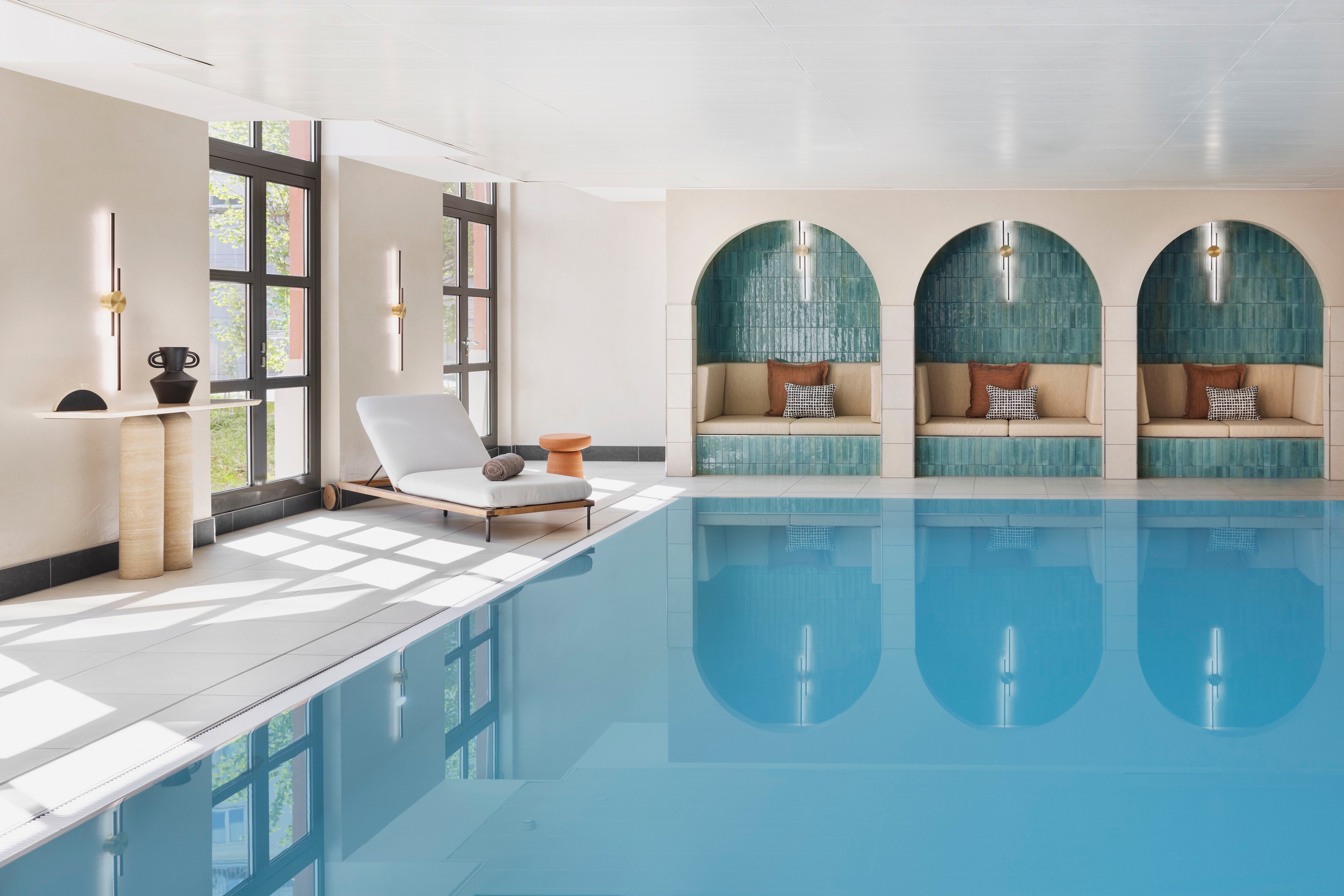 Indoor pool and arched relaxation alcoves at the Imperial Riding School