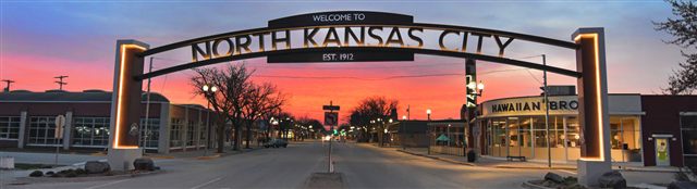 The Welcome to North Kansas City archway over Armour Road at sunset