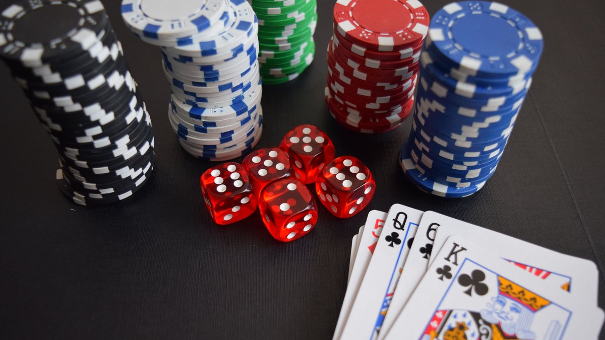 Playing cards and poker chips on a green felt table