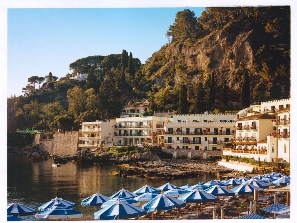 Villa Sant’Andrea and blue beach umbrellas beside Mazzarò Bay