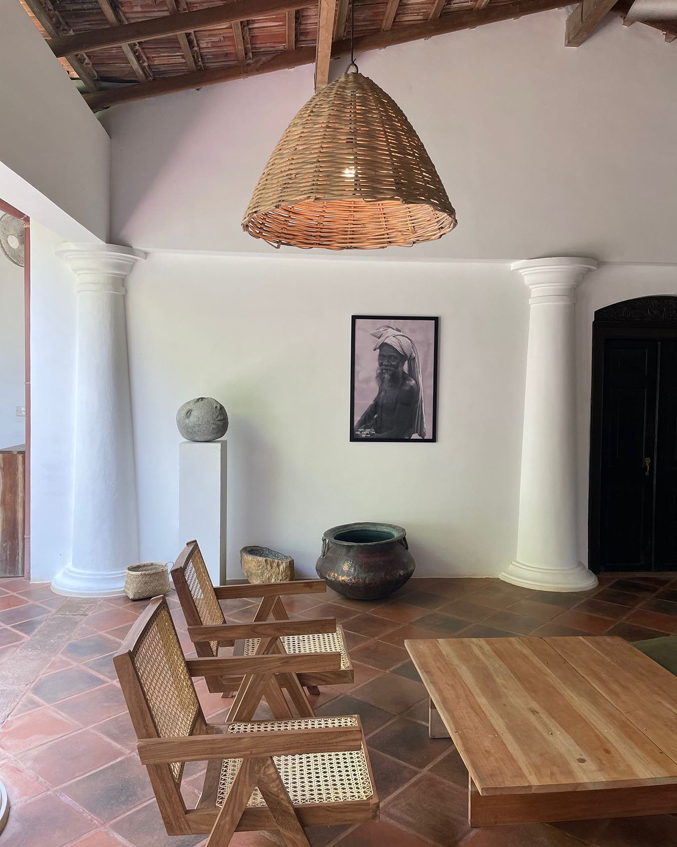 Natural wood seating and woven pendant light inside The Kip