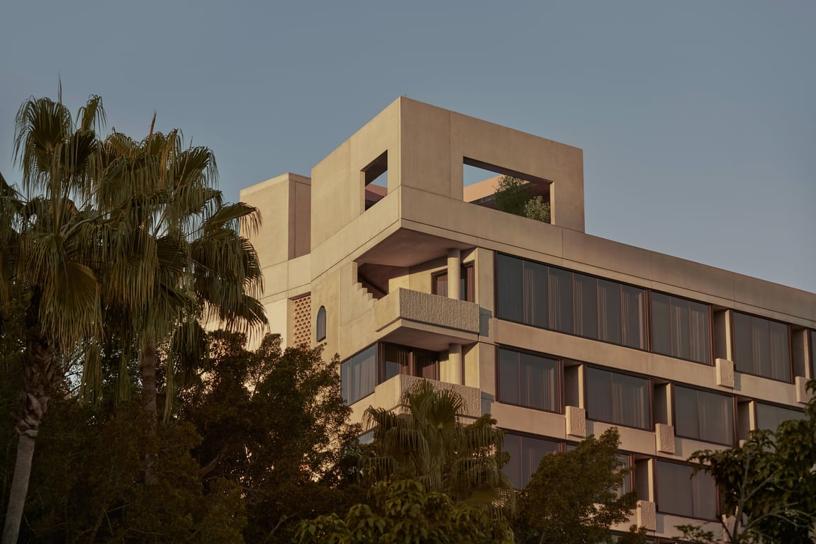 Sculptural pale stone exterior of The Calile Hotel