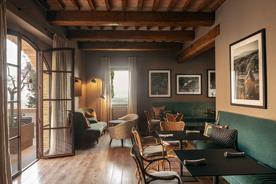 Rastrello lounge with wooden beams and open doors to a balcony