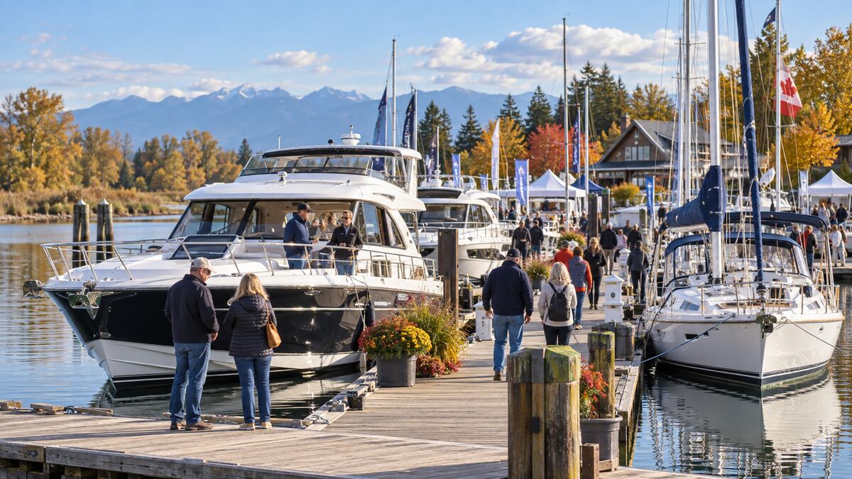 Visitors exploring boats on the water at a fall marina show in Ladner, Delta, British Columbia