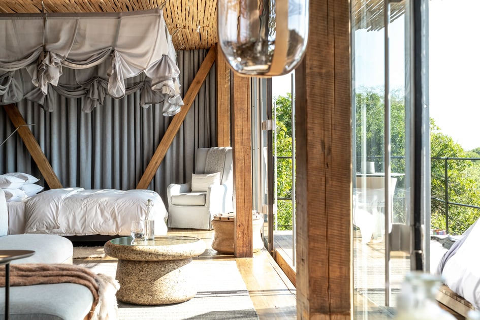 Glass-fronted Singita Lebombo suite with a canopy bed