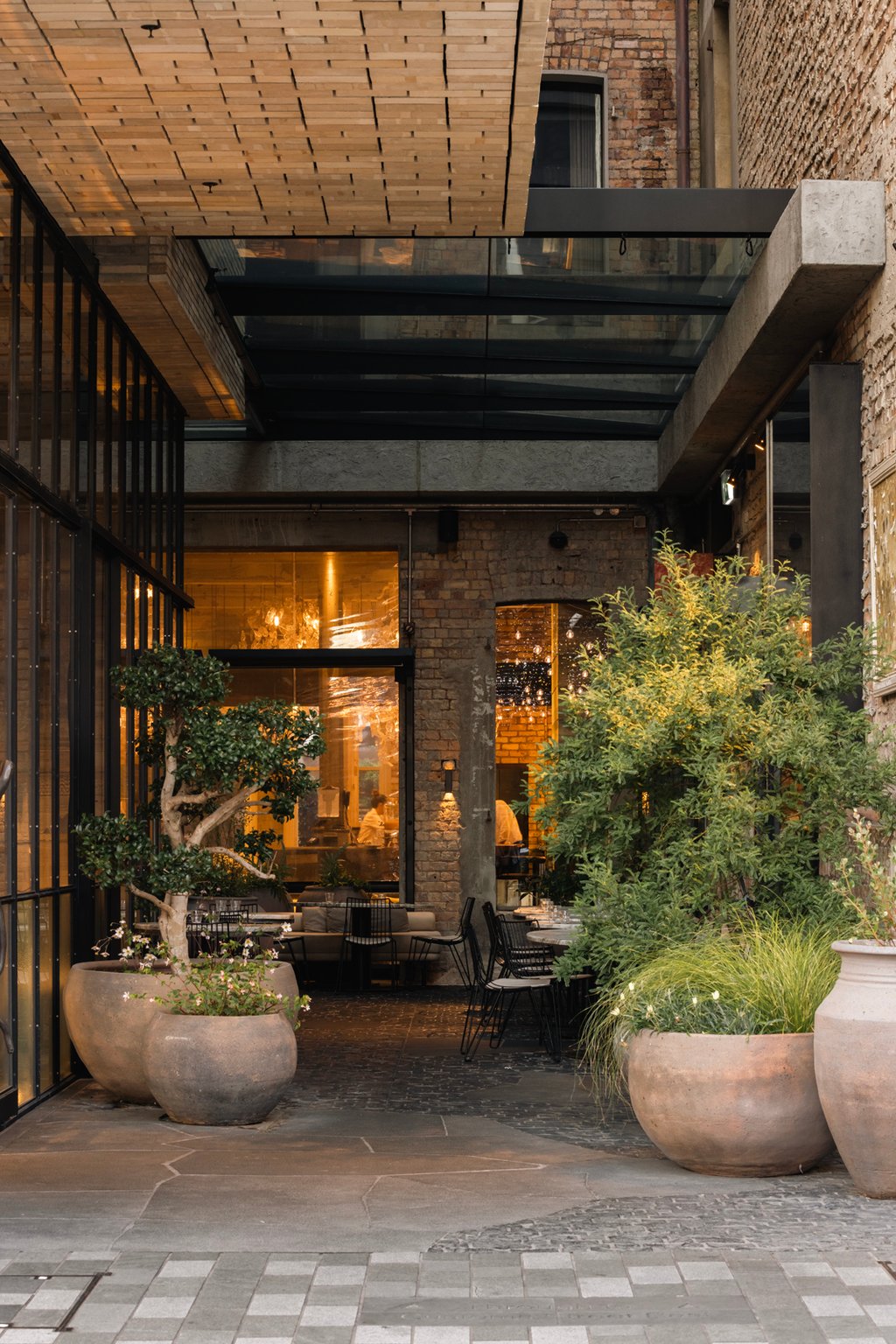 Brick entrance and potted greenery at Hotel Britomart
