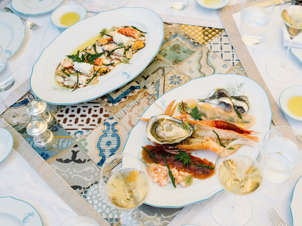 Seafood dishes on a patterned table at Villa Sant’Andrea