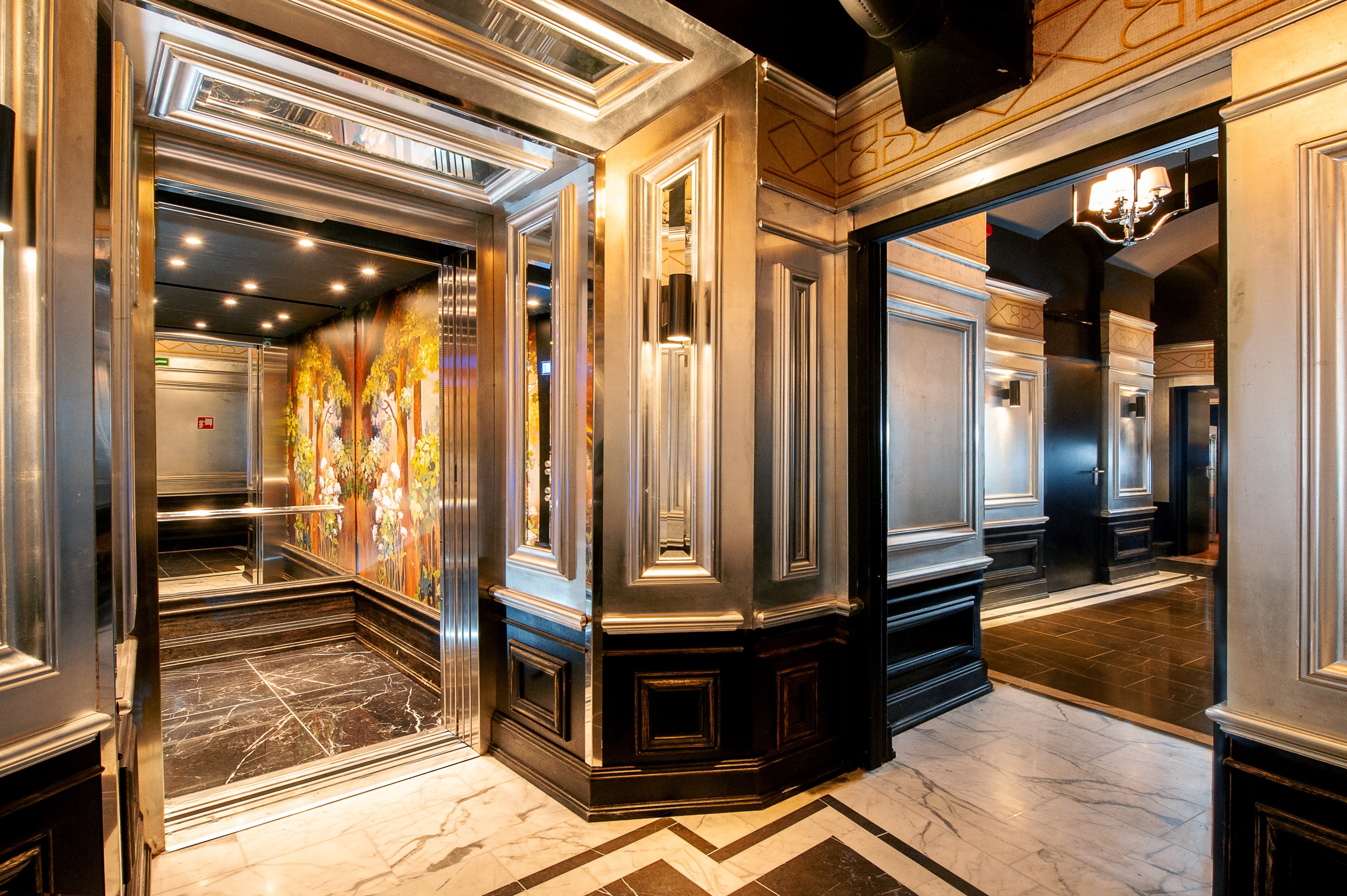 Mirrored hallway and gilded paneling at Balthazar Design Hotel
