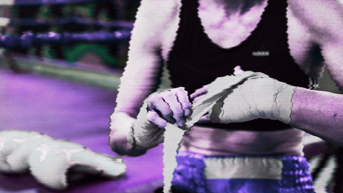Boxer wrapping their hands beside the ring before a fight