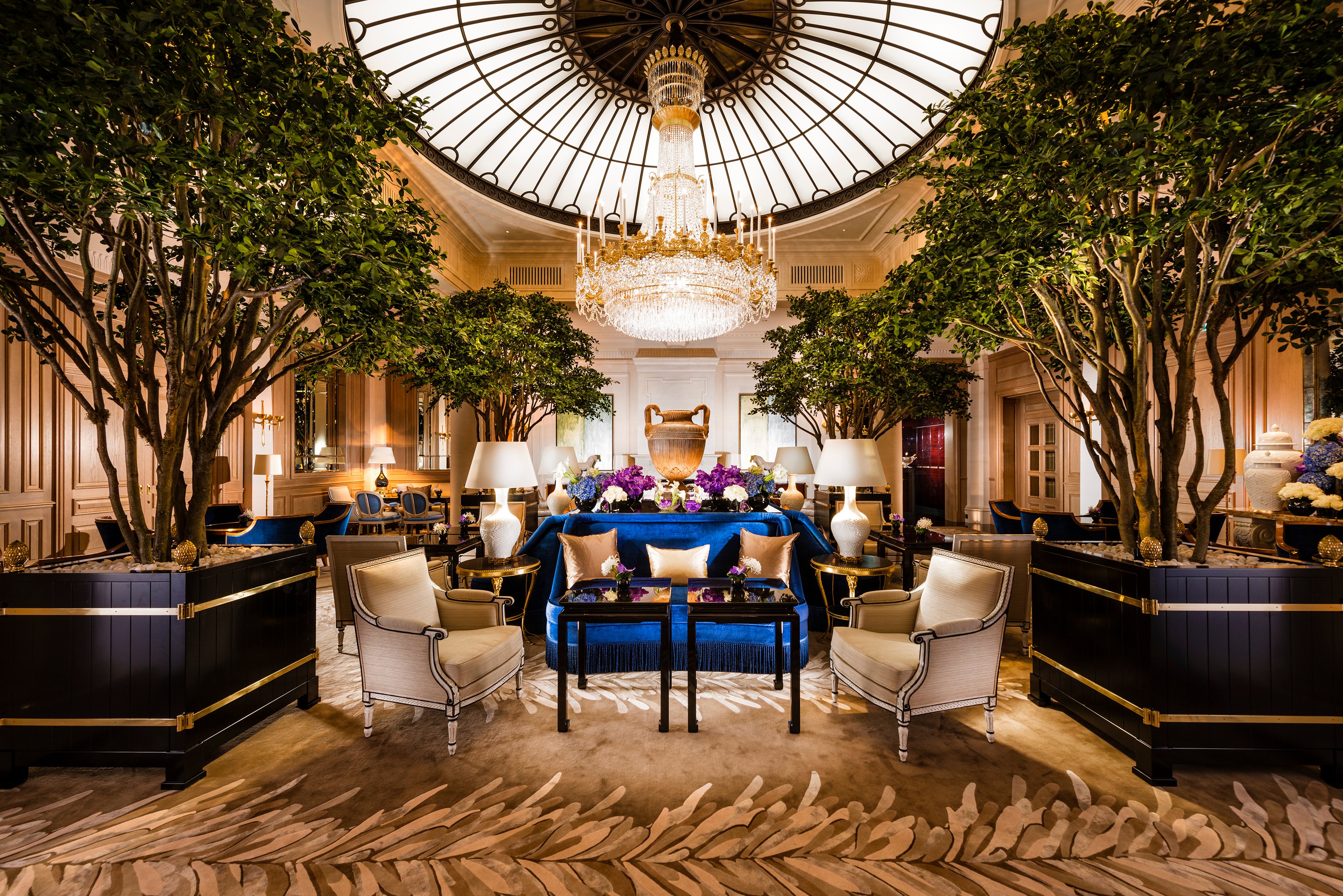 Tree-filled salon beneath a glass dome at Baur au Lac