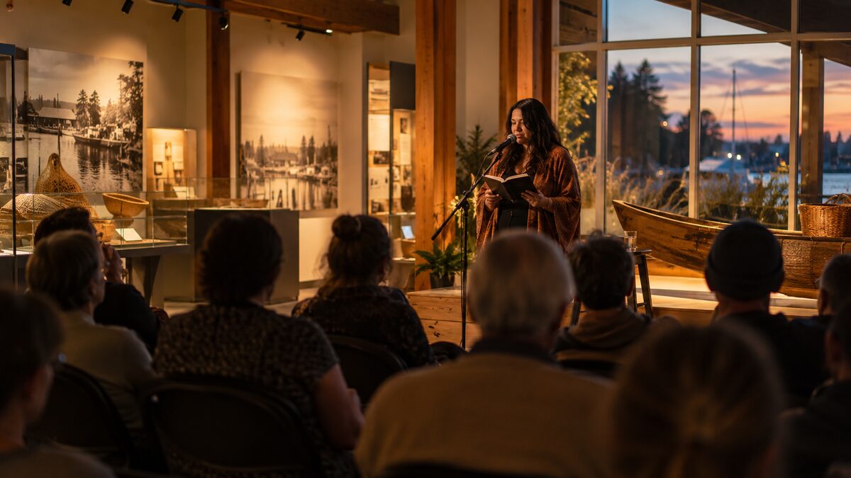 Photorealistic editorial illustration of a Words on Fire spoken-word evening in Ladner, Delta BC