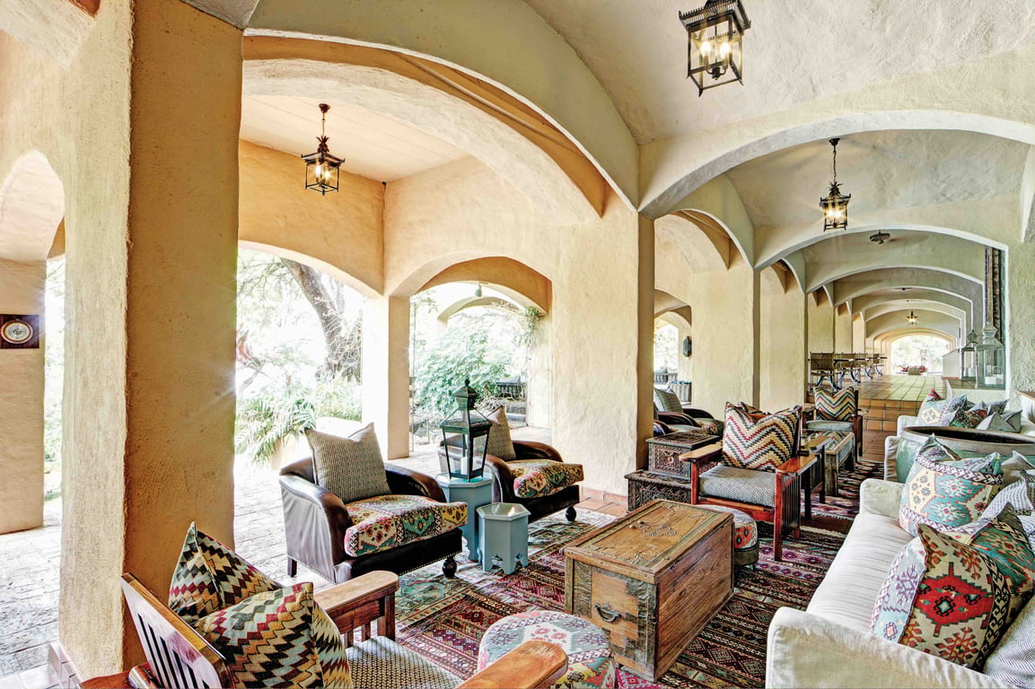 Arched lounge filled with colorful cushions at Chobe Game Lodge