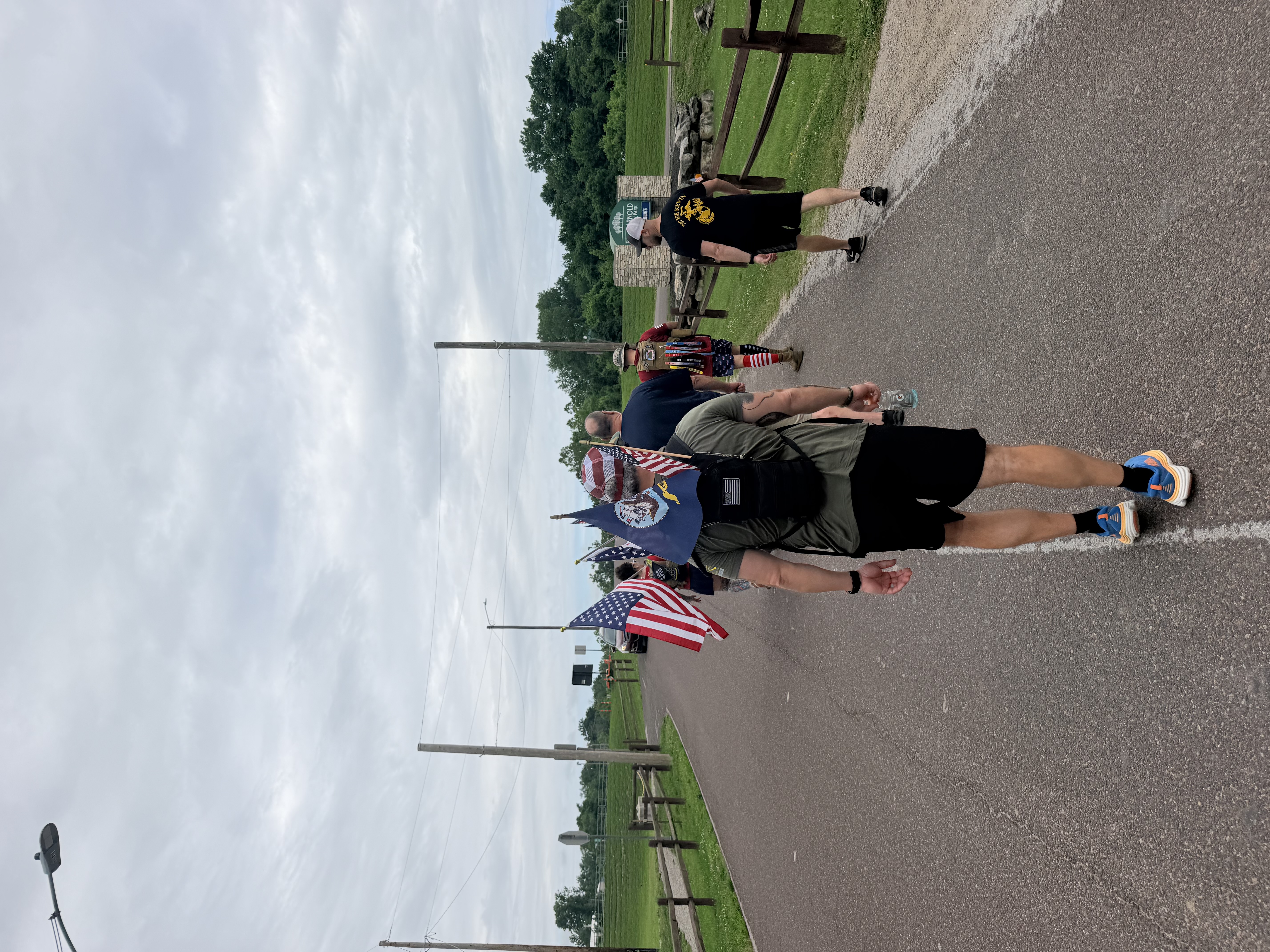 Participants carrying flags during the second annual Ruck March in Arnold