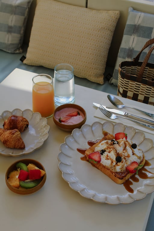 Breakfast spread with fruit, pastries, juice, and savory dishes