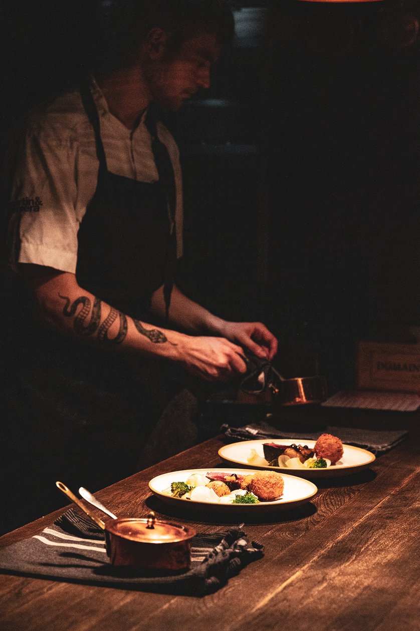 Chef preparing a plated dish at Niehku Mountain Villa