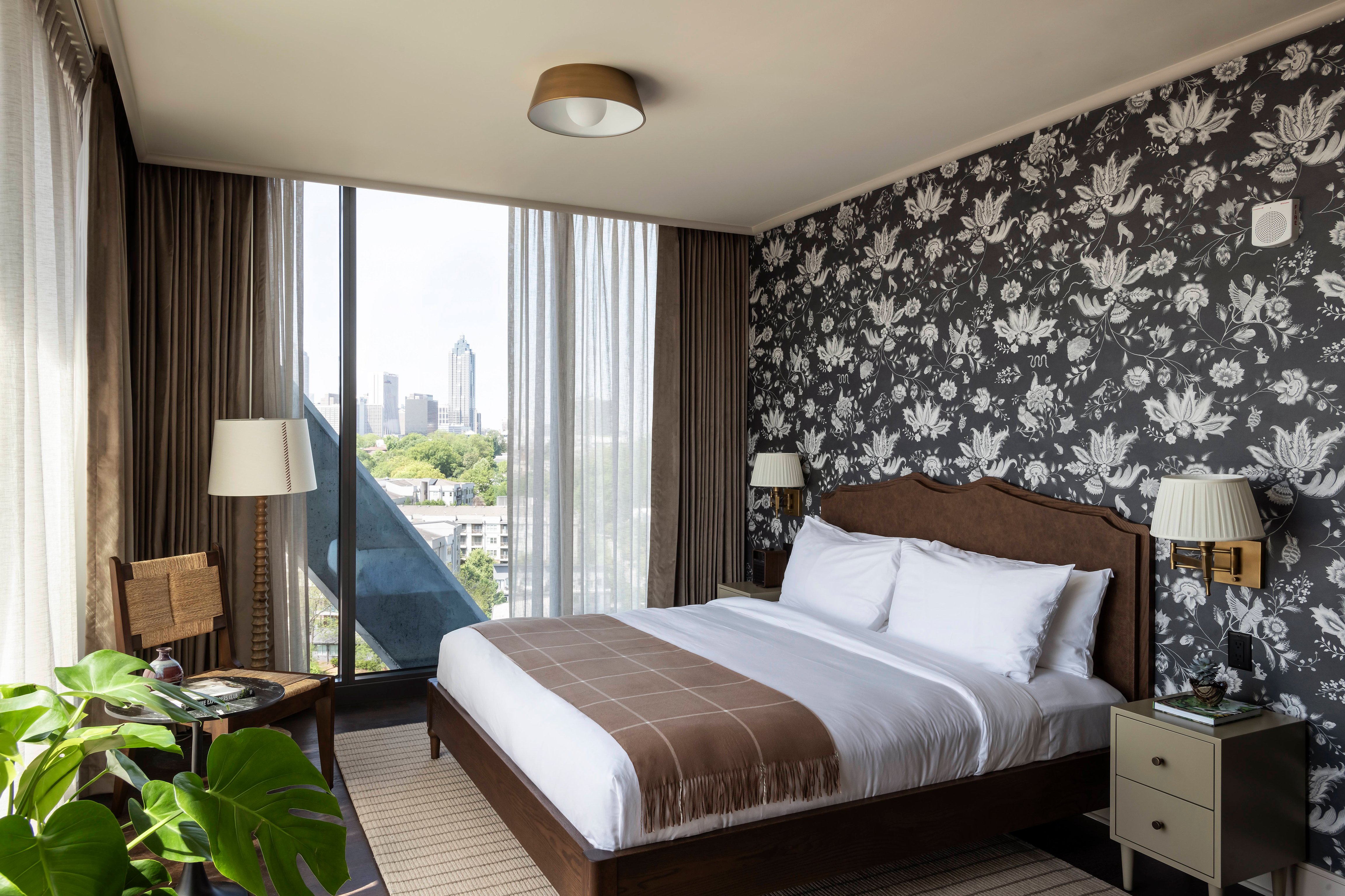 Forth Atlanta guest room with botanical wallpaper and skyline views