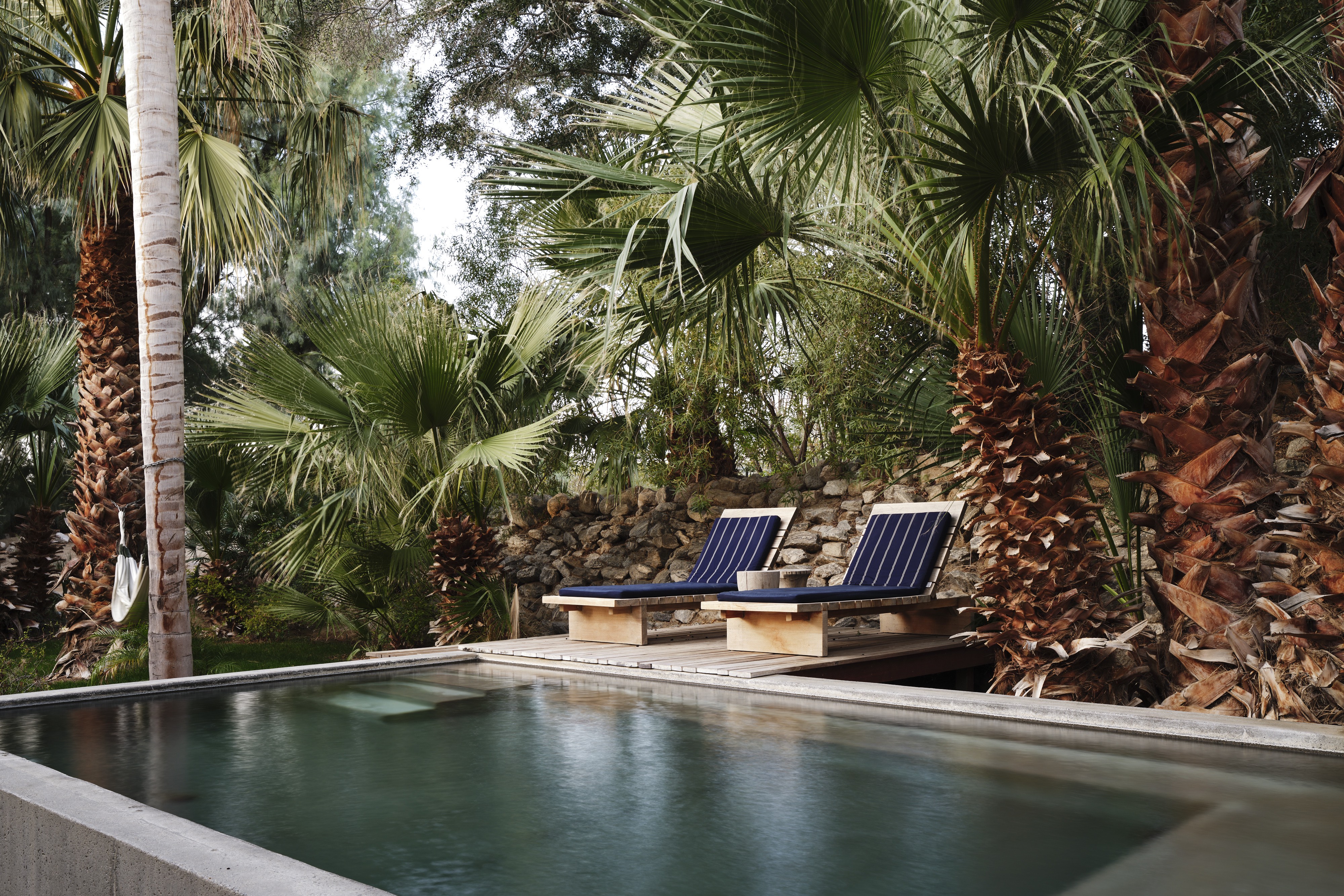 A palm-shaded mineral soaking pool at Two Bunch Palms