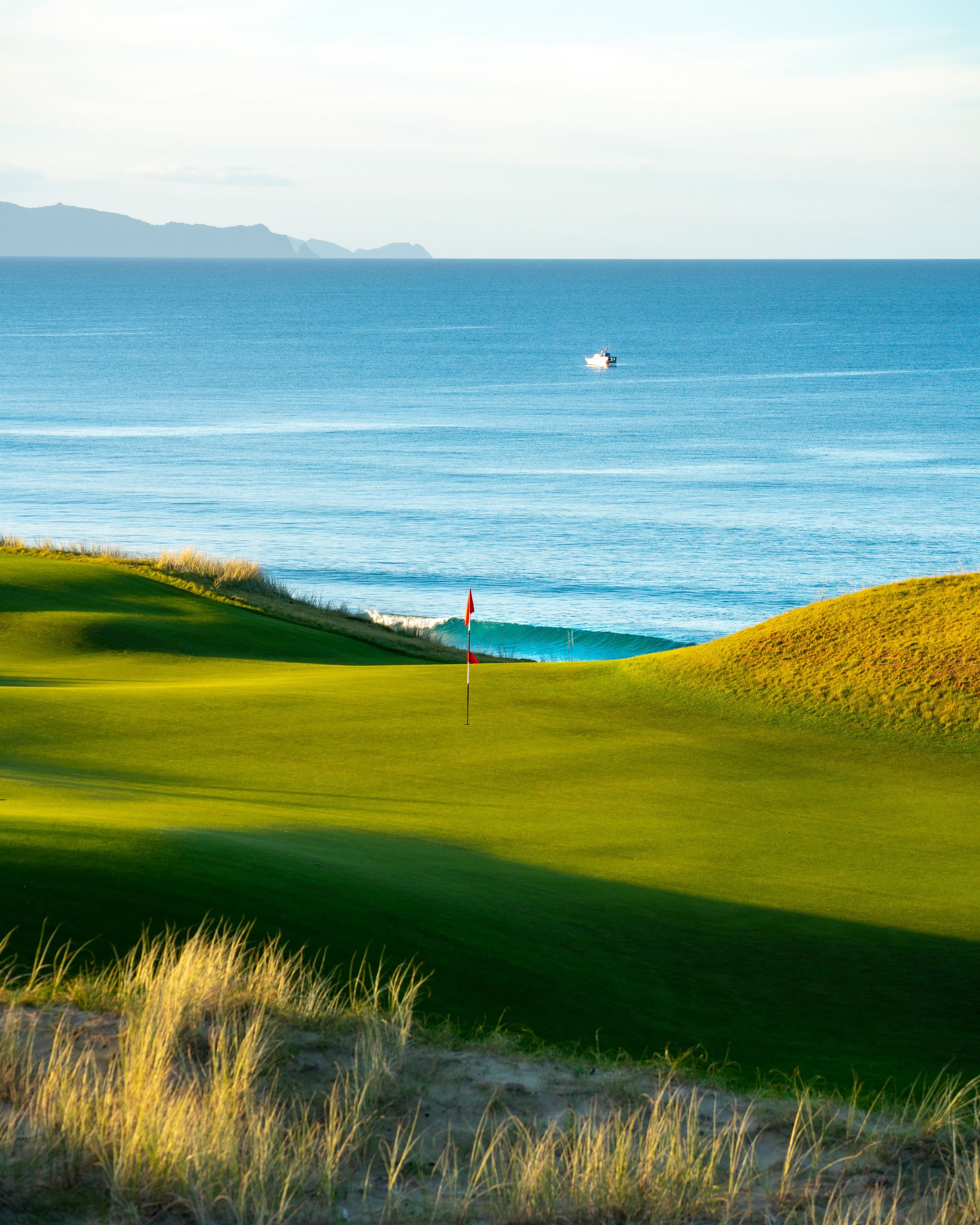 Coastal golf green overlooking the blue ocean