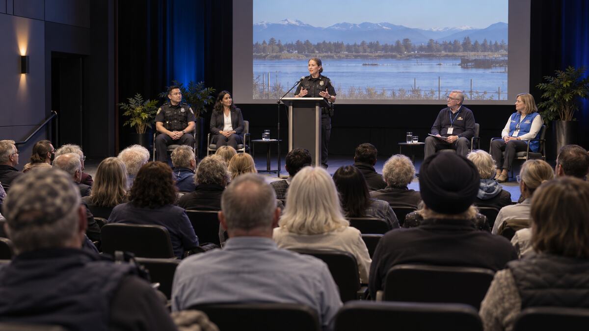 Residents listening to community safety speakers at a theatre forum in Delta, British Columbia