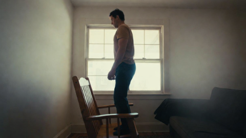Man standing up from a sturdy chair without using his hands