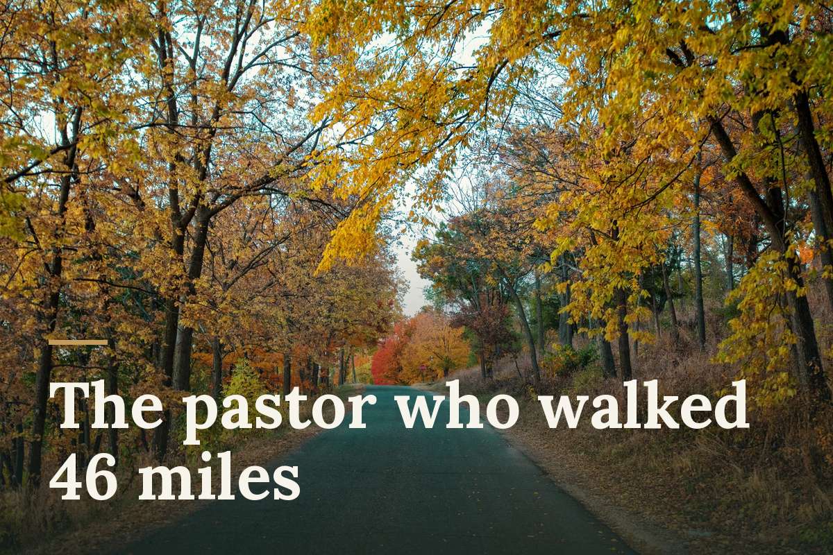 The pastor who walked 46 miles. An empty country road lined with yellow autumn trees