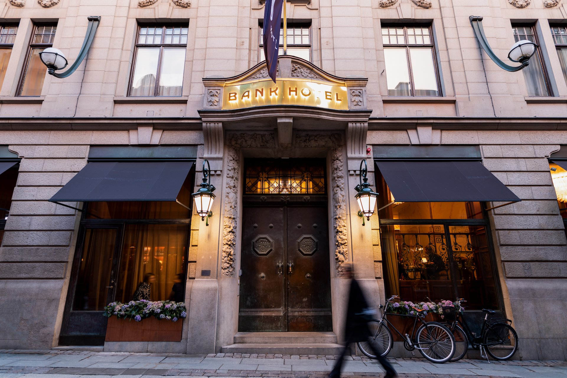 Bronze entrance doors and historic facade of Bank Hotel