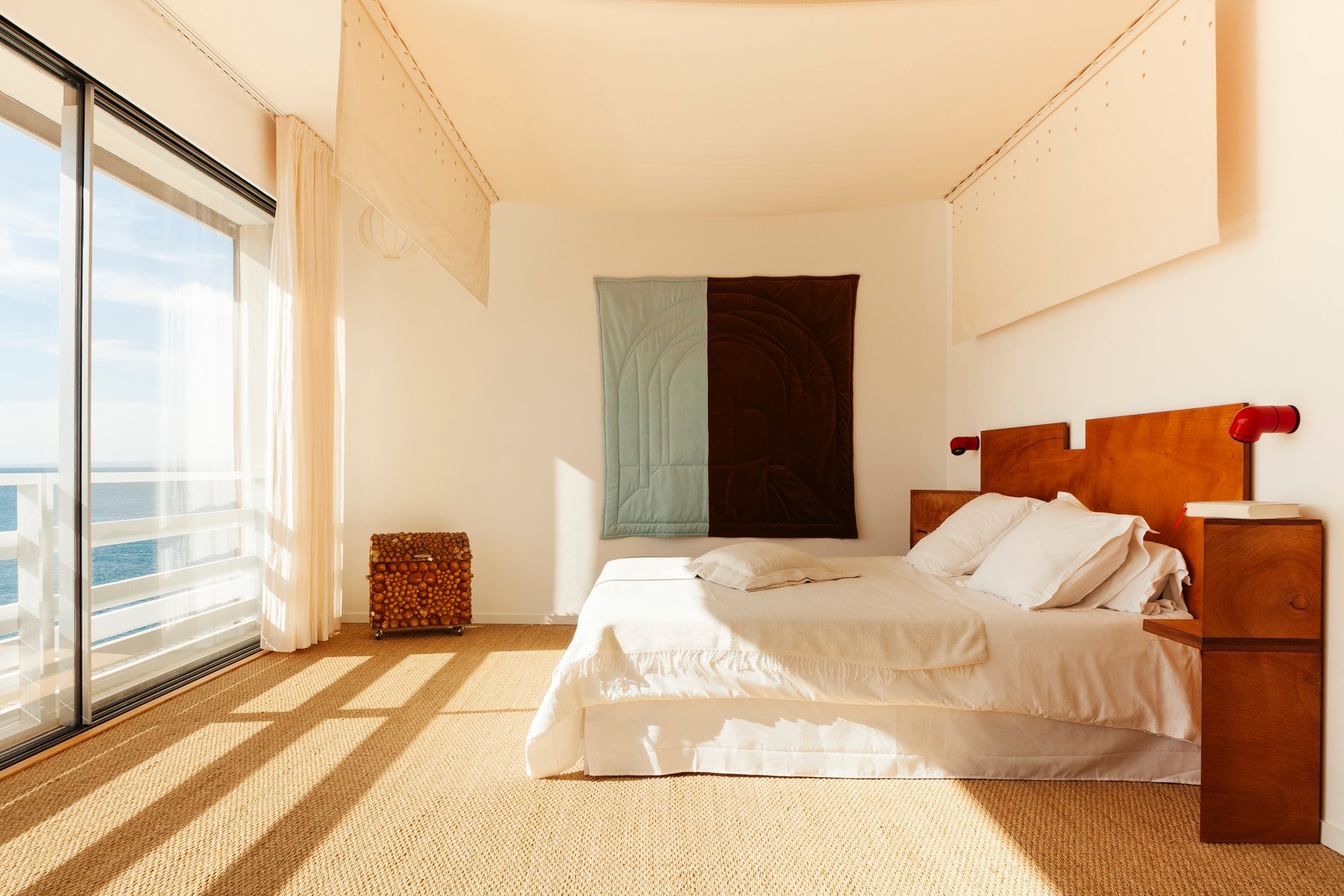 Minimalist Tuba Club bedroom with striped sunlight across the floor