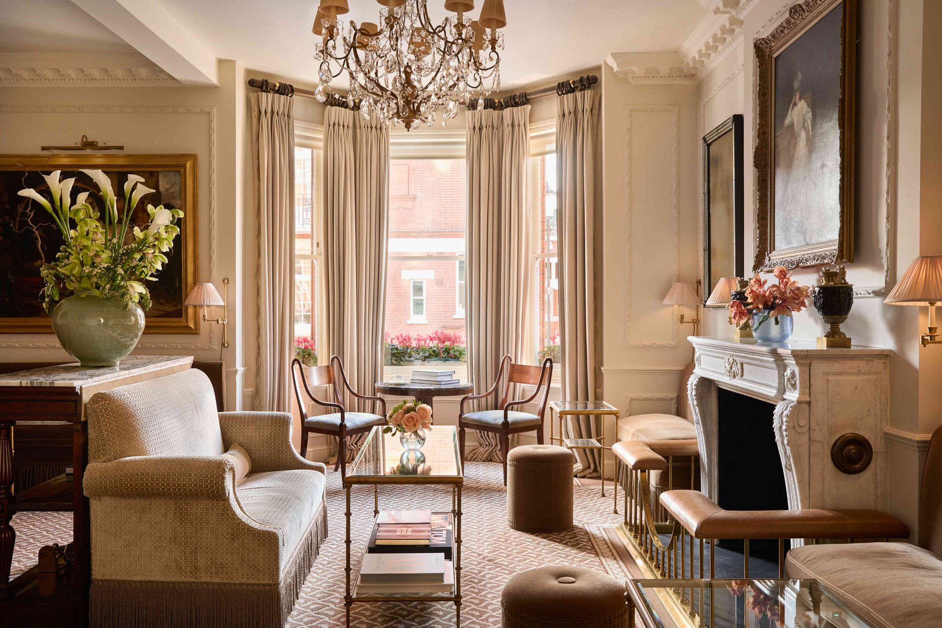 Drawing room with chandeliers and upholstered seating at The Egerton House Hotel