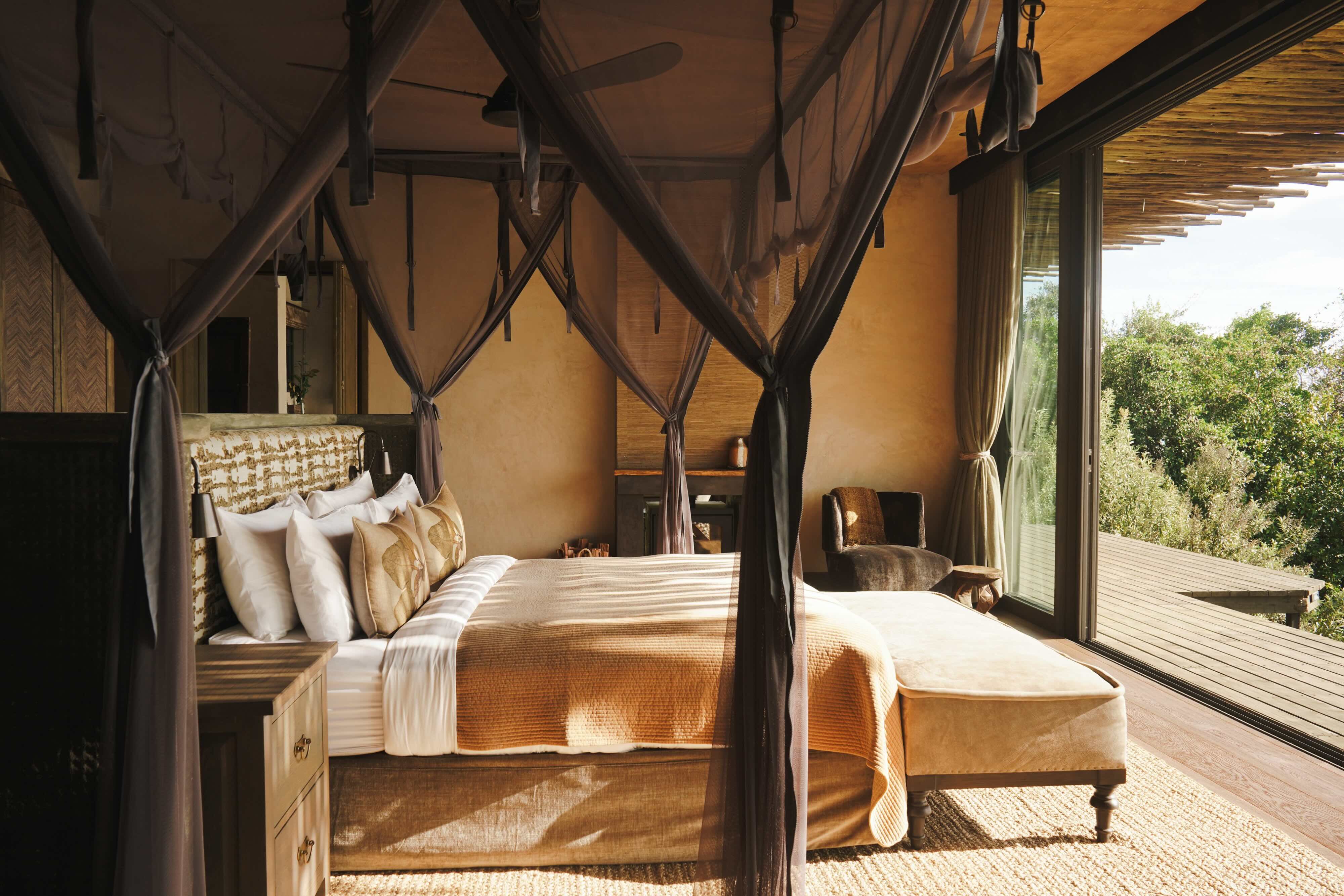 Canopied guest bed overlooking the landscape at Wild Hill