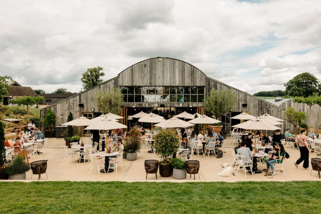 Barn and outdoor gathering area at Soho Farmhouse