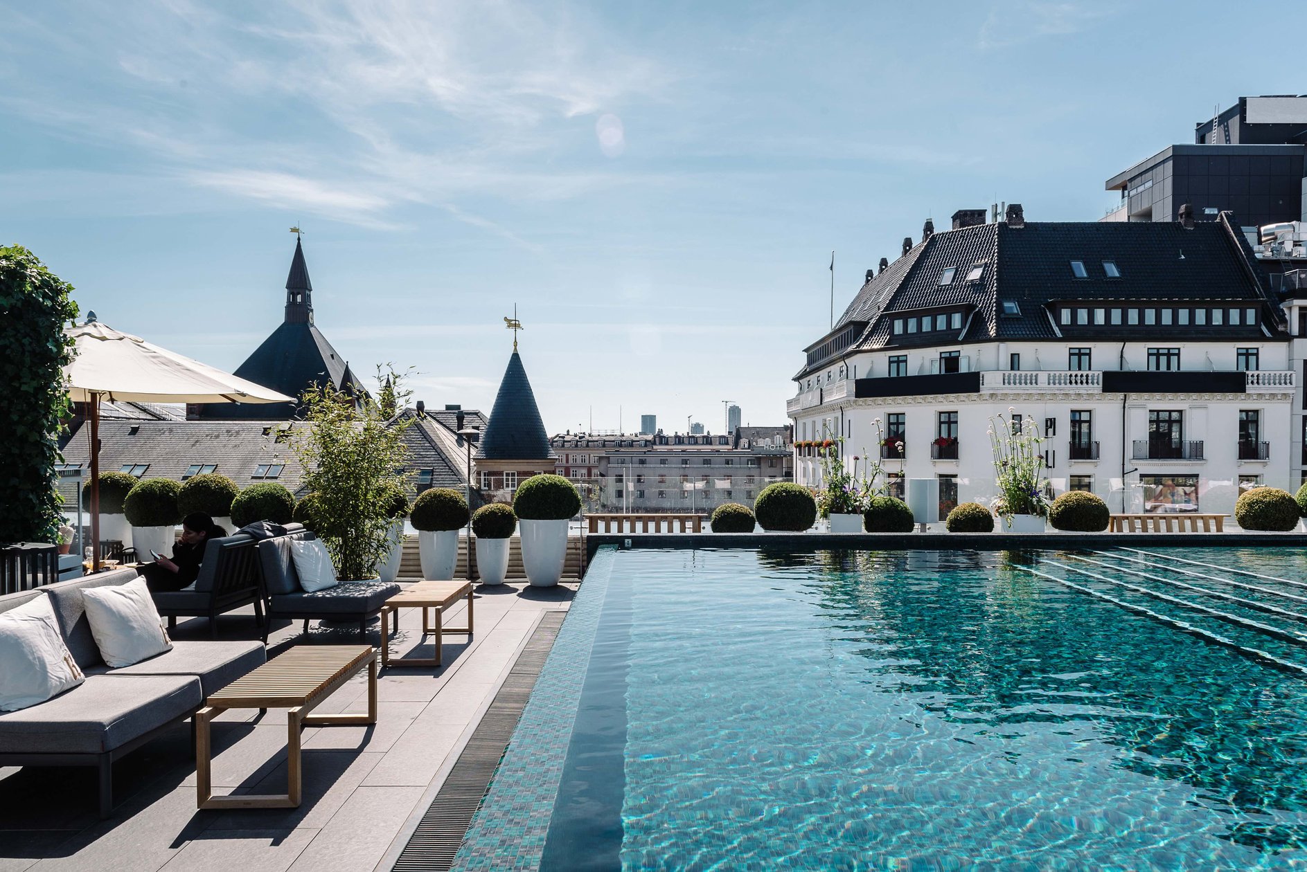 Nimb Hotel rooftop pool with Copenhagen rooftops beyond