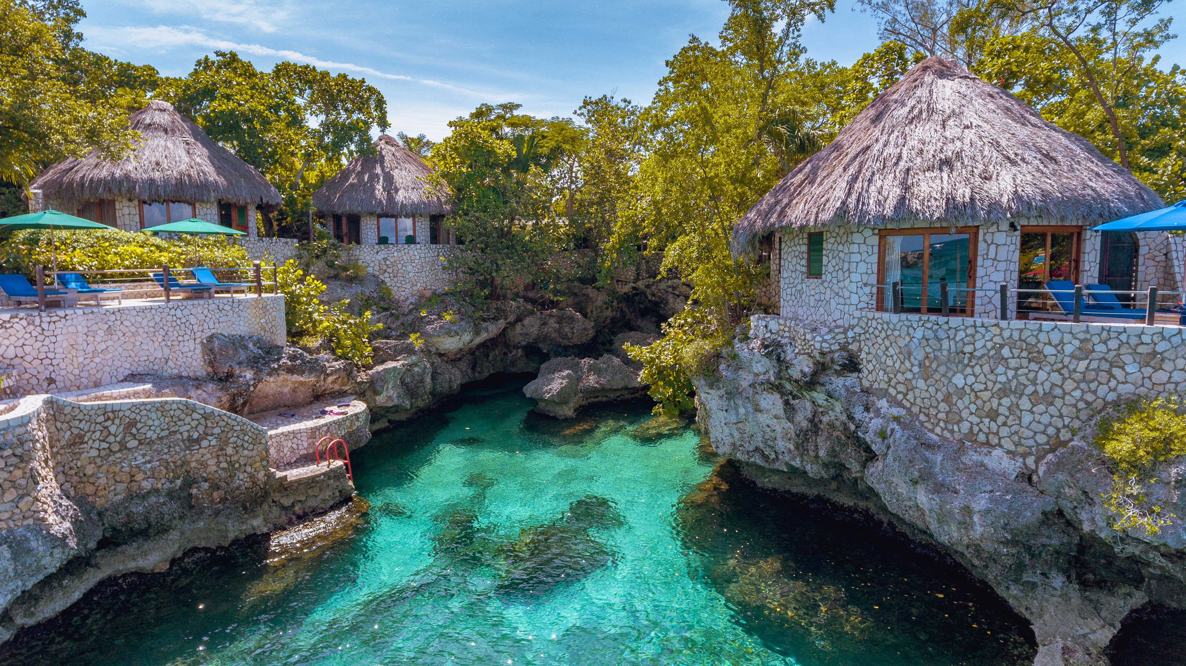 Rockhouse Hotel villas perched above a turquoise cove in Negril