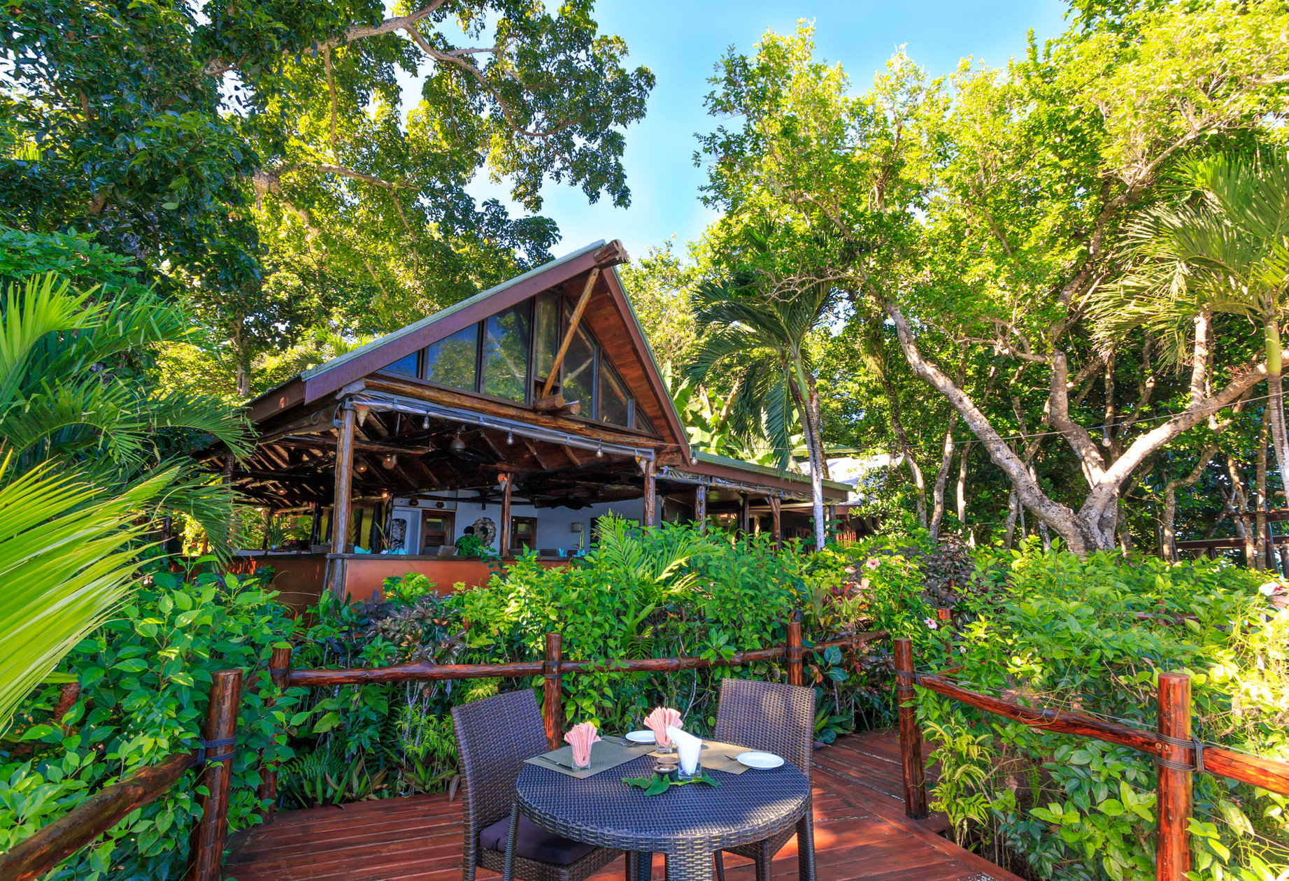 Forest-framed wooden pavilion and outdoor dining table