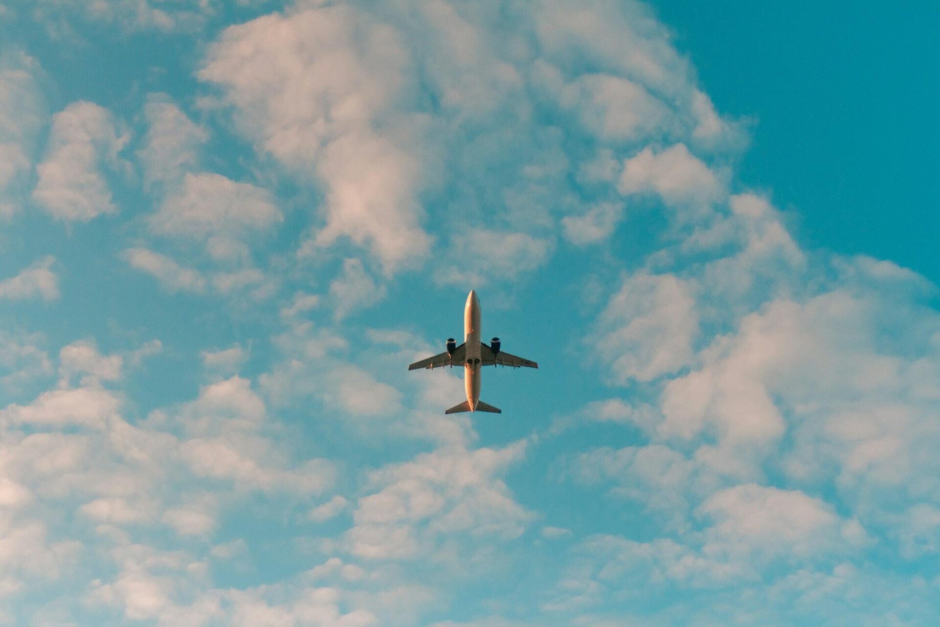Airplane in blue sky over Portland