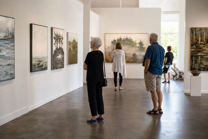Visitors viewing local landscape art at Gallery 1710 in Tsawwassen, Delta BC